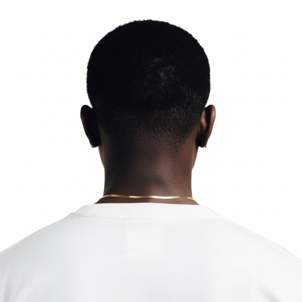 CameroonJewels La Discrète gold herringbone chain necklace worn by a model against a white background